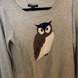 Grey sweater with brown and swore owl.